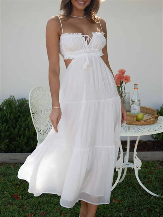 White boho sling dress with spaghetti straps, tiered midi skirt, lace-up bodice bow.