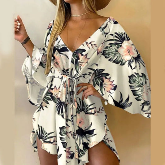 White floral leaf print boho party dress with V-neck, tie waist, and flutter sleeves.