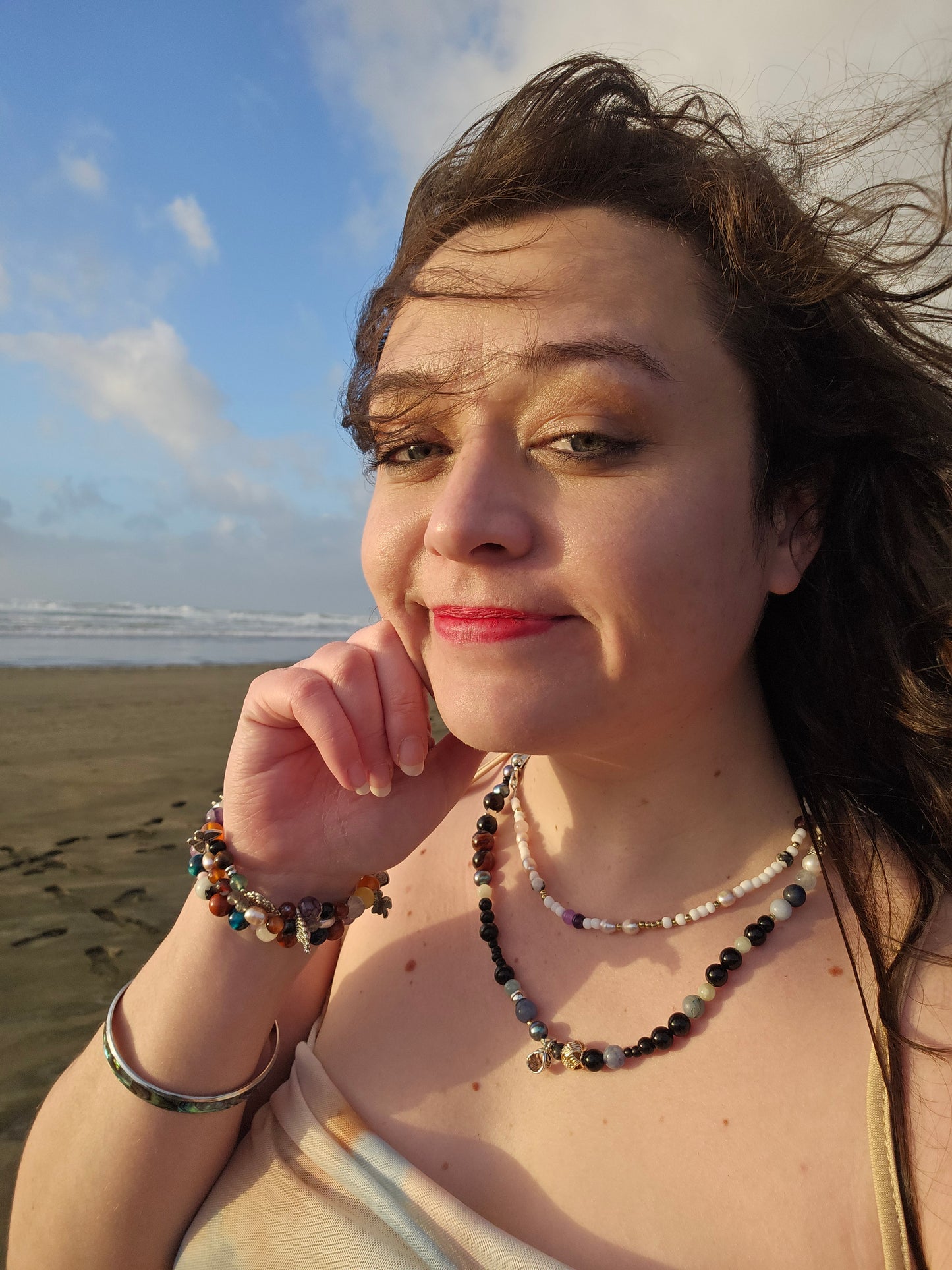 Woman on a beach with a blue sky and ocean in the background