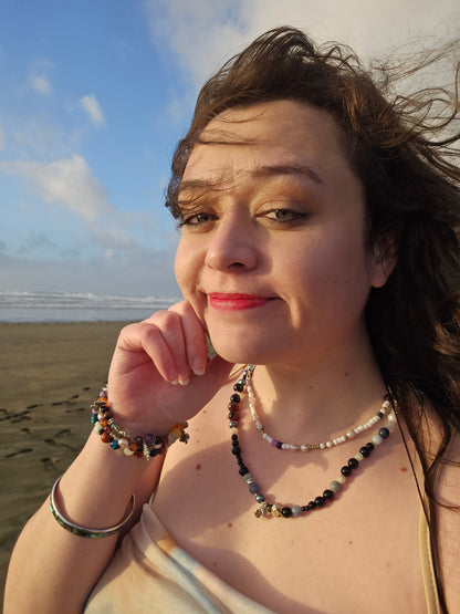 Woman on a beach with a blue sky and ocean in the background