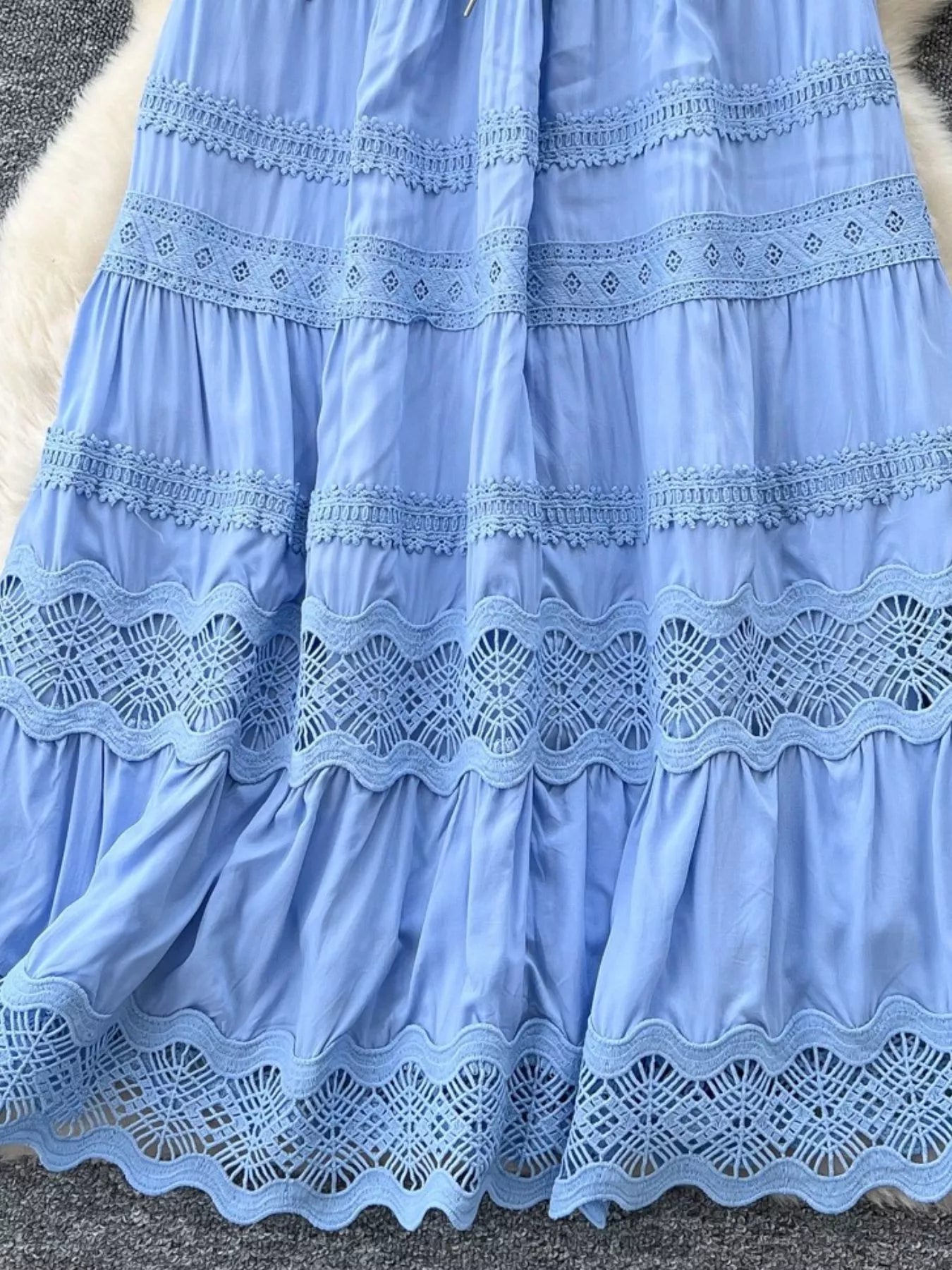 Blue tiered skirt detail with scalloped lace panels and crocheted hem