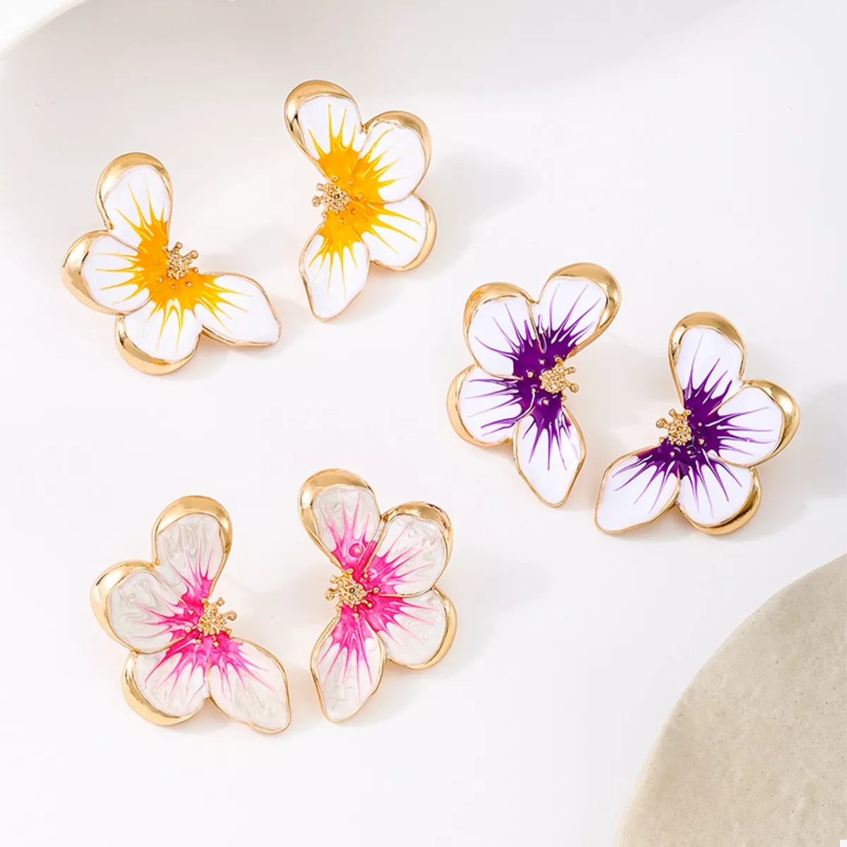 Butterfly stud earrings assortment: orange, purple, and pink petals with gold accents