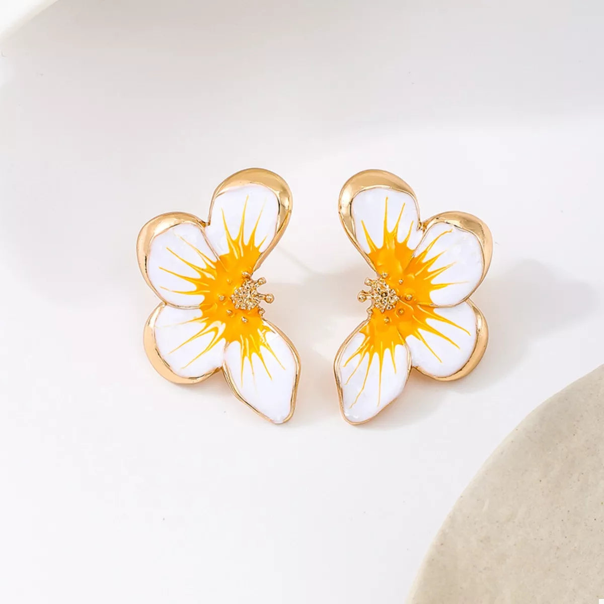 Orange butterfly stud earrings with white petals and gold-tone frames, jeweled center