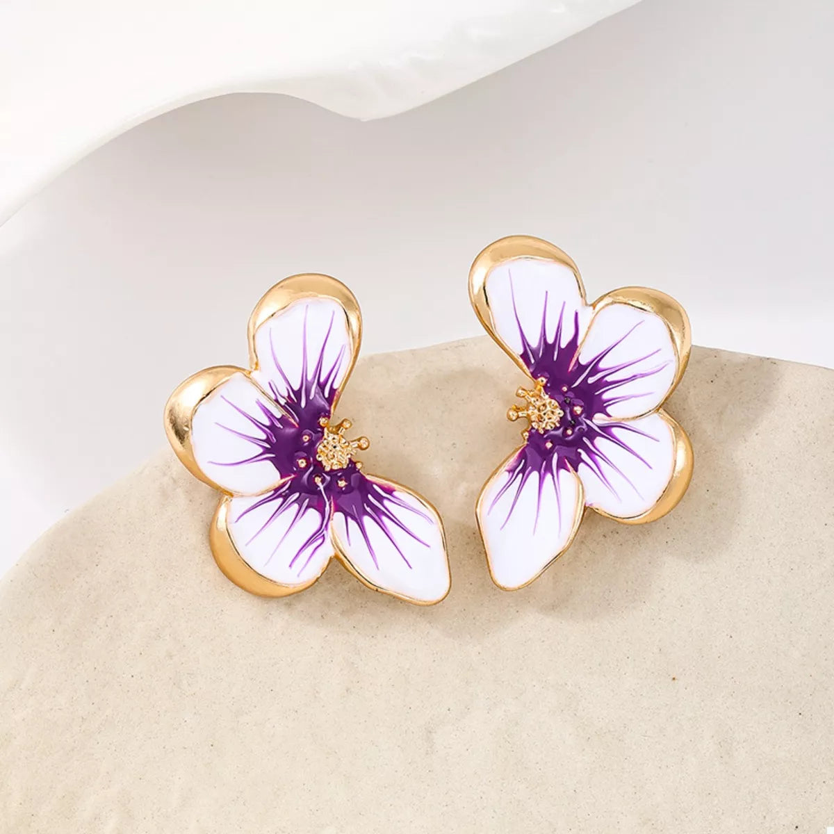 Gold-tone butterfly stud earrings with purple enamel wings and small gold center
