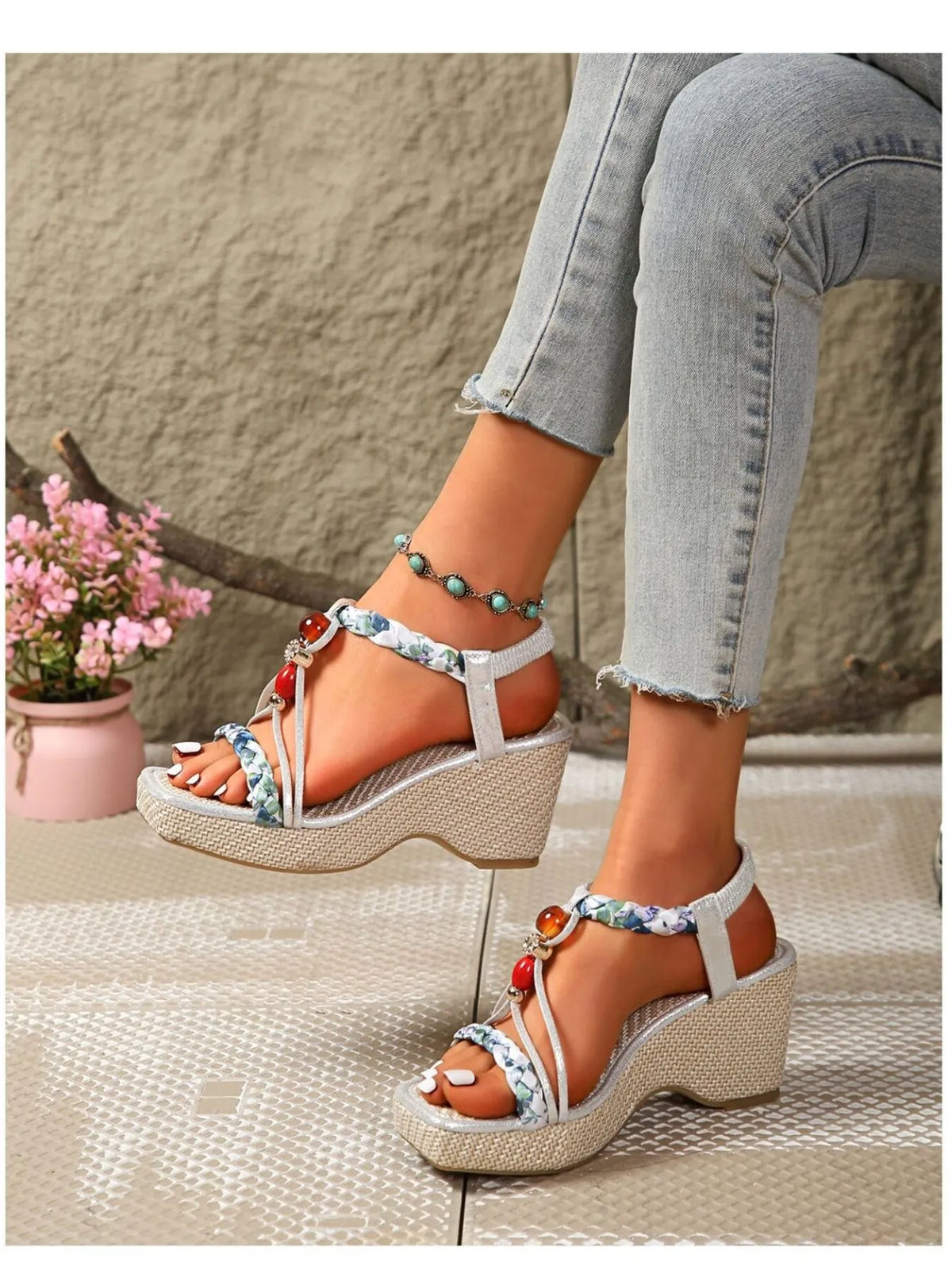 Wedge sandals with beige platform wedge, blue floral ankle strap, and red bead charm