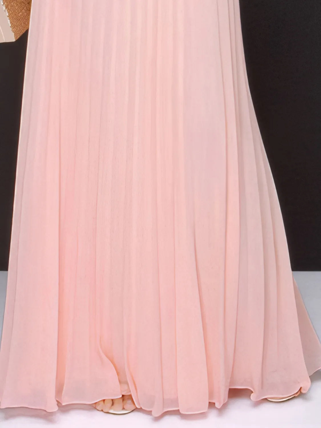 Blush pink pleated maxi dress hem with back slit
