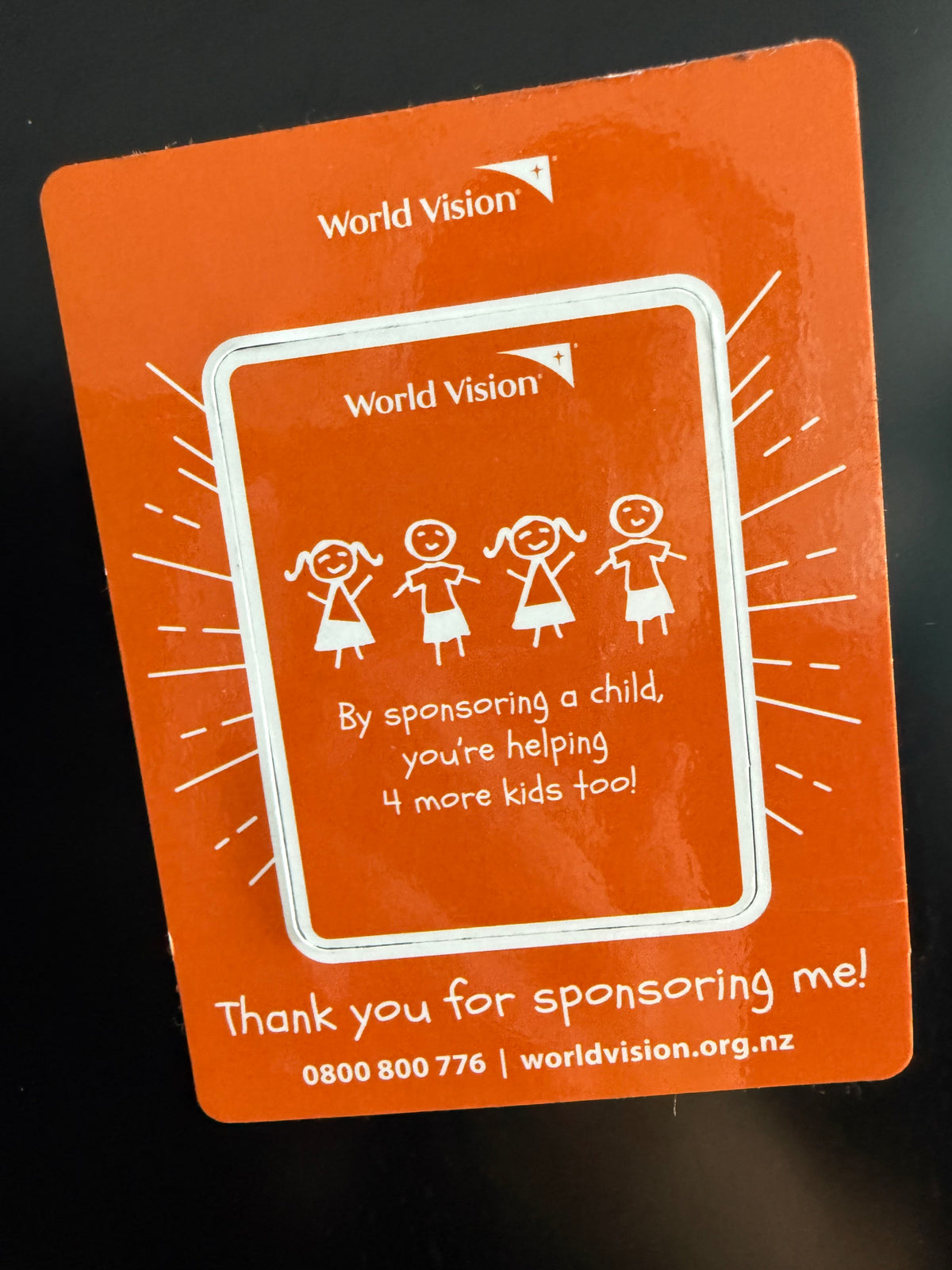 Orange World Vision fundraiser card with thank-you message and child sponsor icons