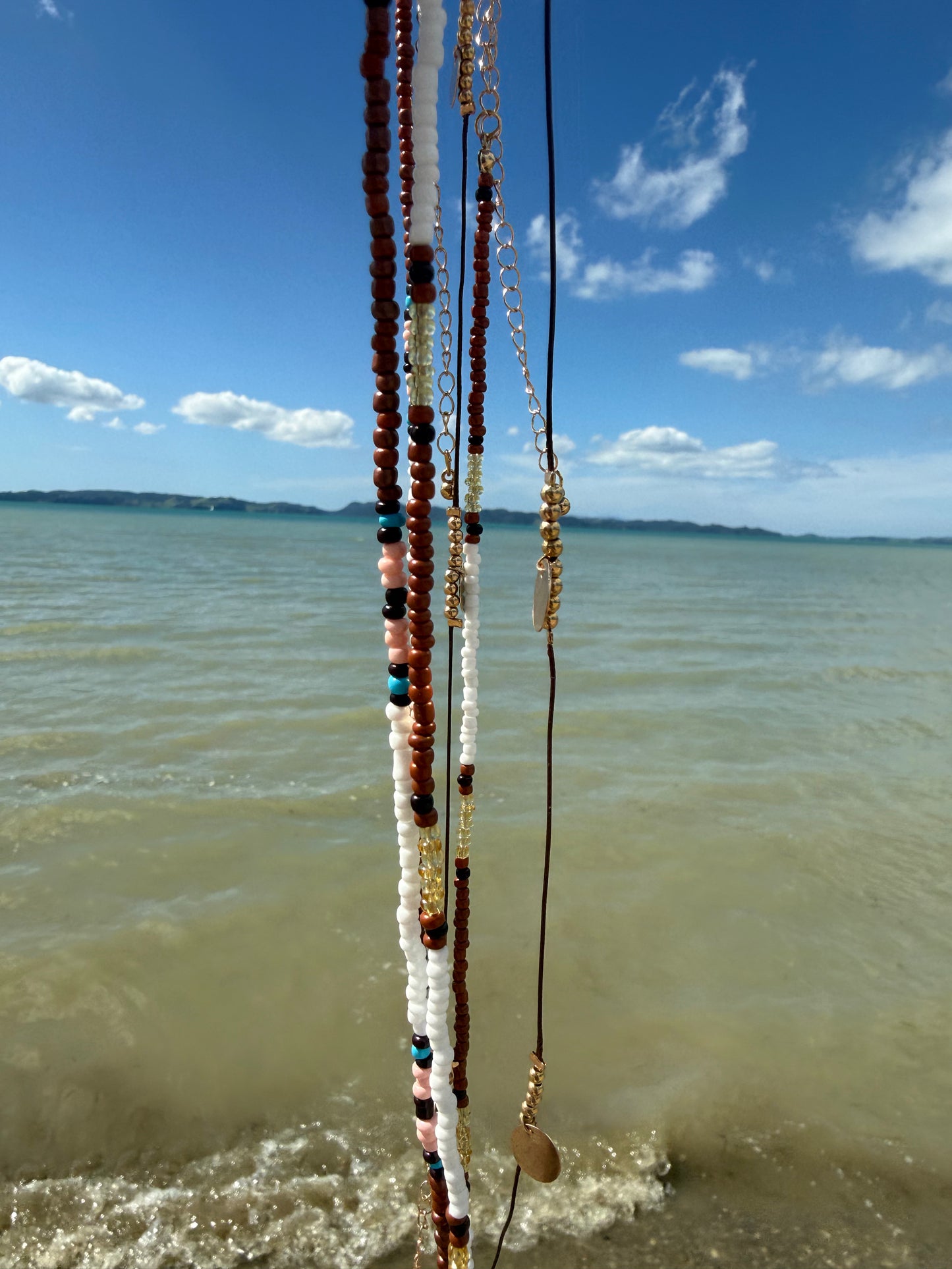 Boho beaded body chain strands with dark red, black, and white beads