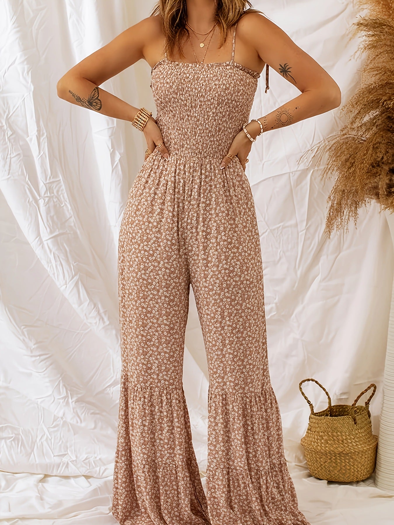 Light beige floral sleeveless jumpsuit with square neck, gathered waist, wide legs