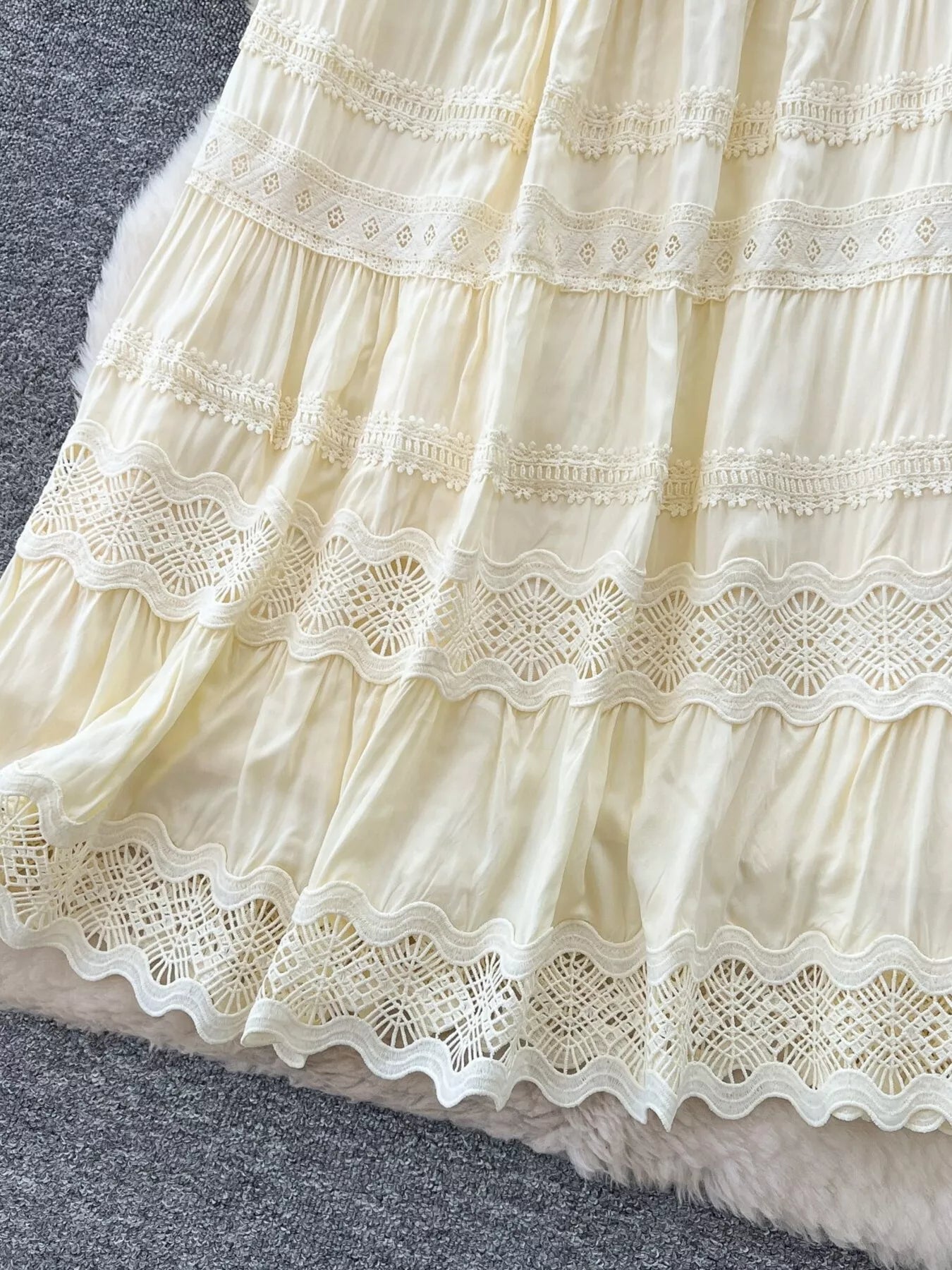 Cream skirt hem with scalloped lace crochet and layered ruffle tiers