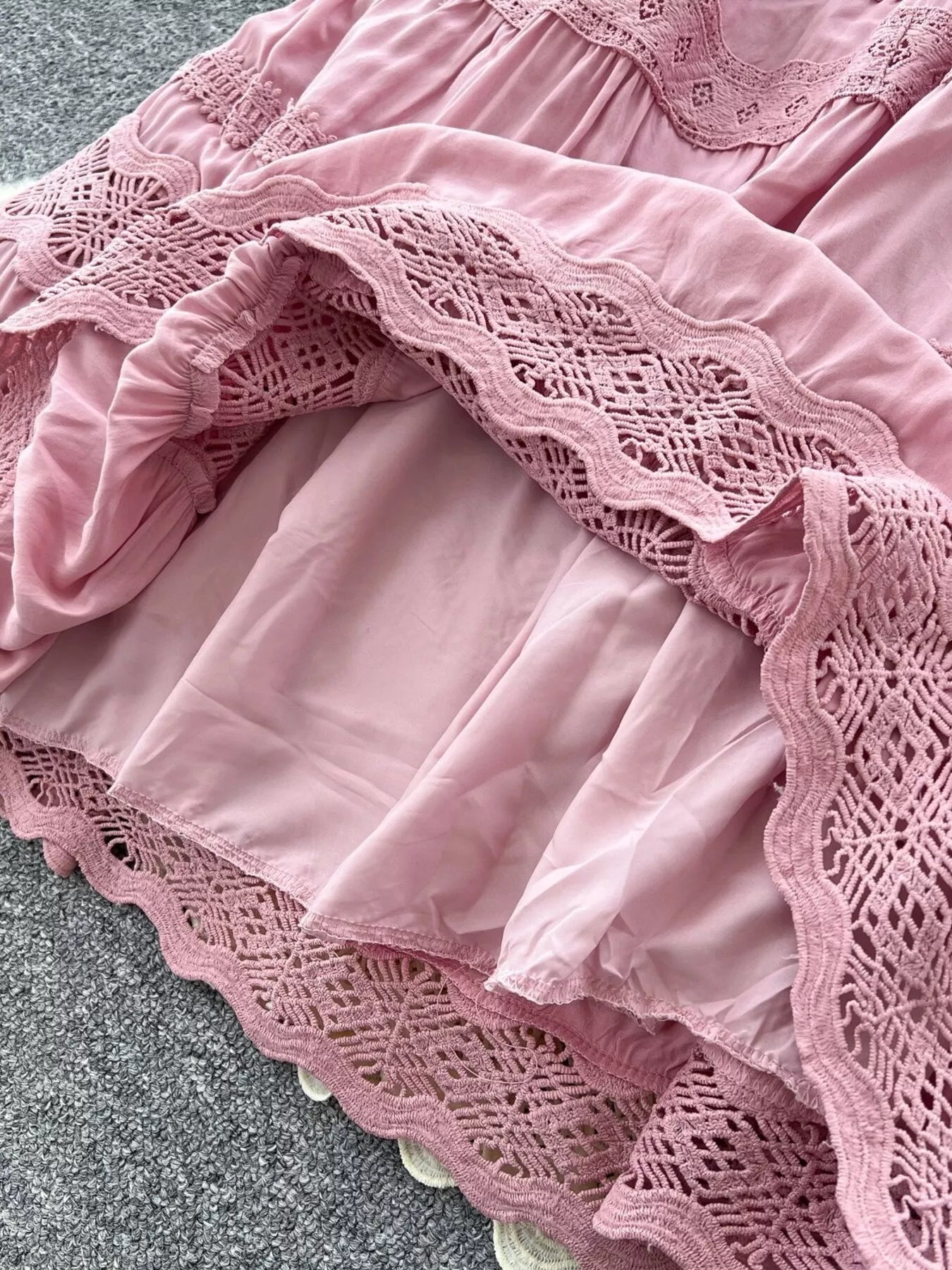 Pink tiered skirt with lace trim and gathered ruffle panels