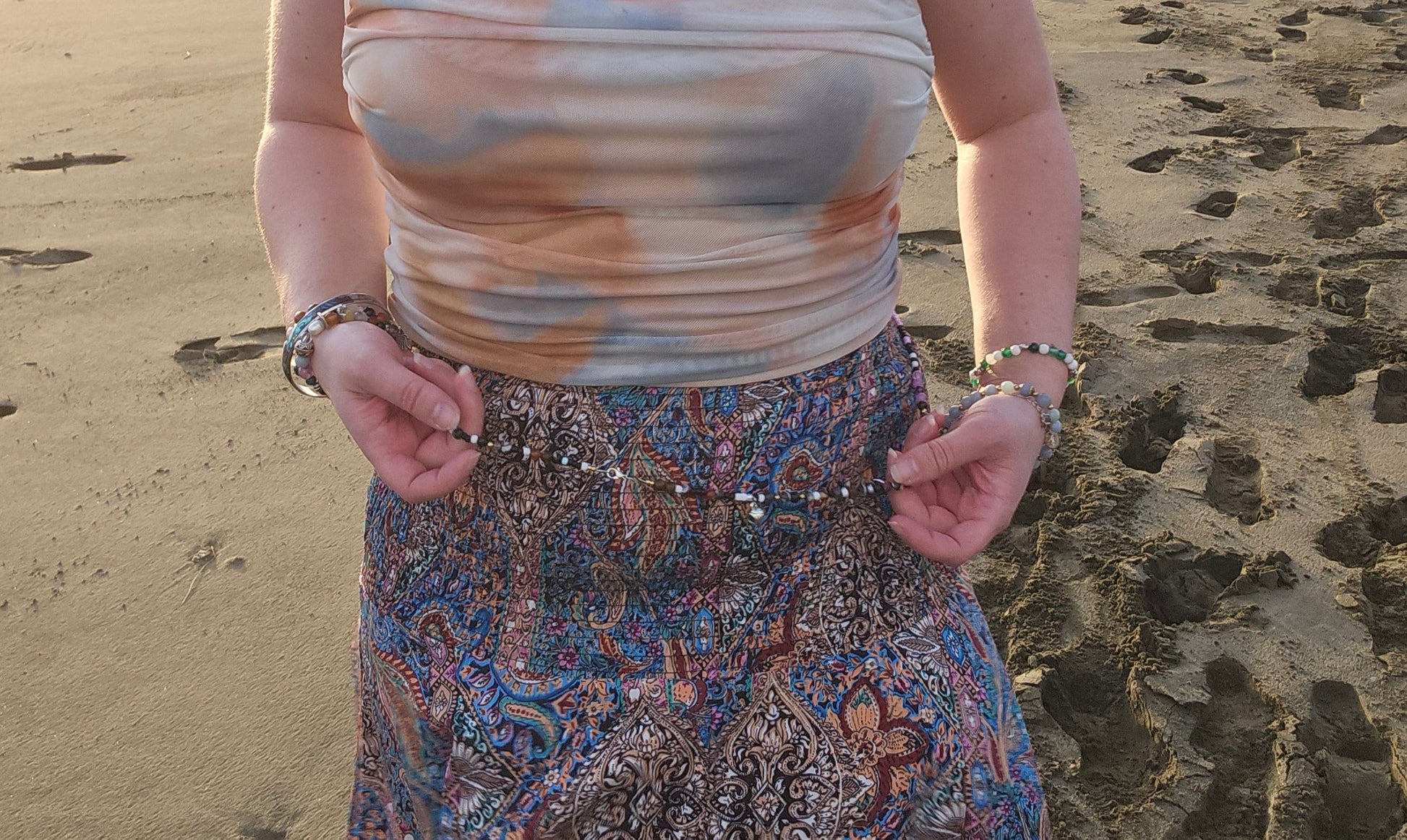 Person standing on a beach with a scenic background